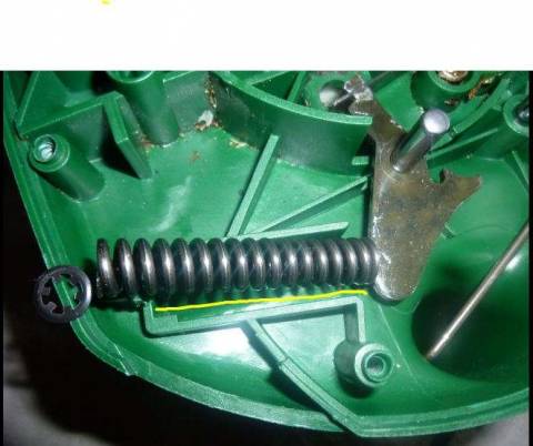 Chainsaw Spring sits in plastic mold that slots into metal pronged component.JPG